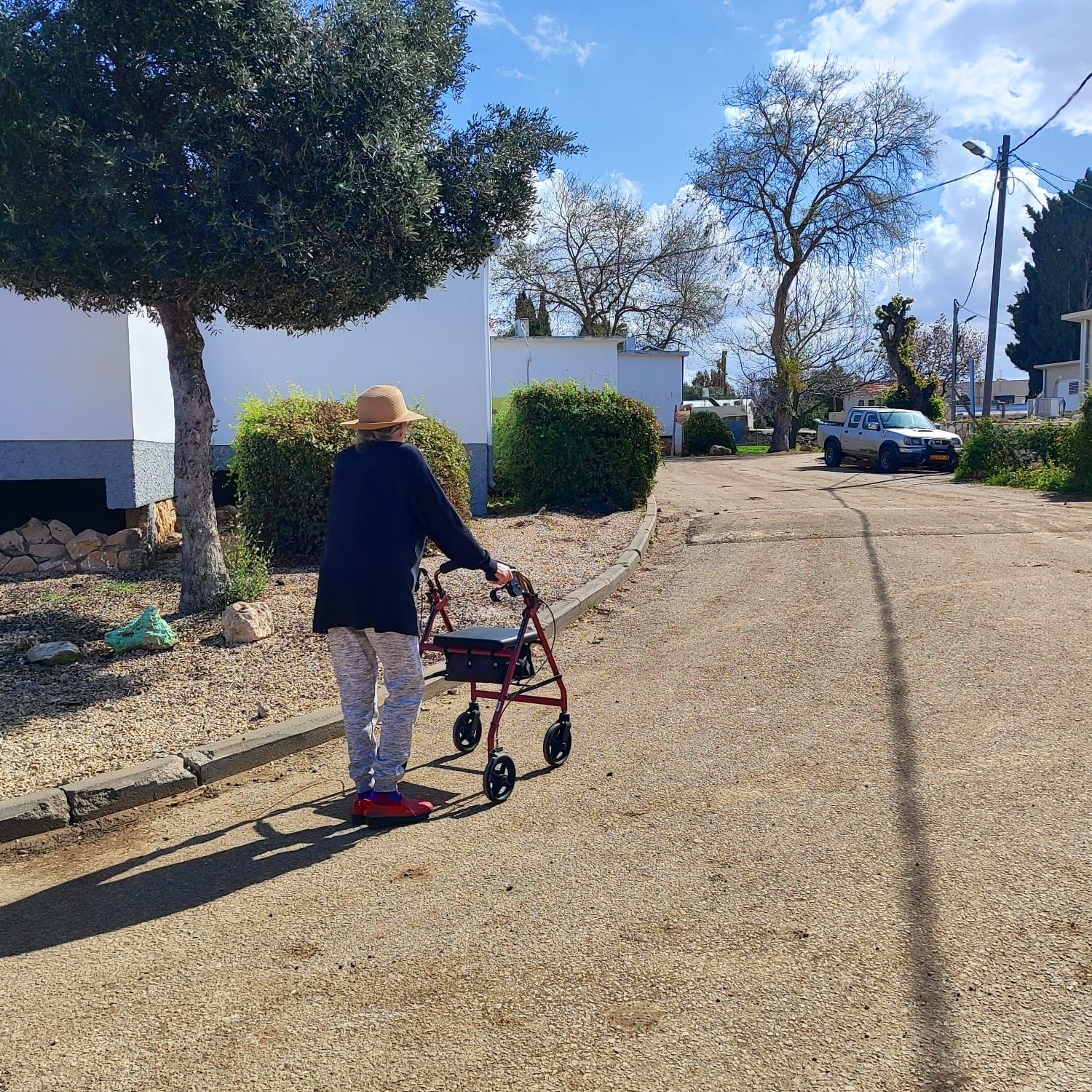 Señora mayor con movilidad reducida pero independiete. Andador con asiento. 